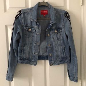 Denim jacket with logo detailing on sides.